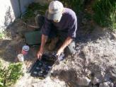 a Cedar Hill Sprinkler Repair team member checks a valve box 